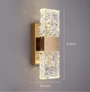 Unique Collection of Art Deco Sconces with elegant design and glowing crystal accents in gold finish.