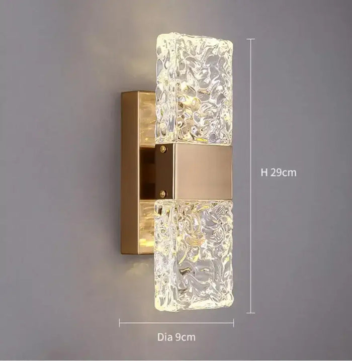 Unique Collection of Art Deco Sconces with elegant design and glowing crystal accents in gold finish.