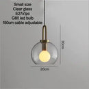 Grey Frosted Sphere Glass Hanging Lamp with clear glass design and adjustable cable for versatile home decor.