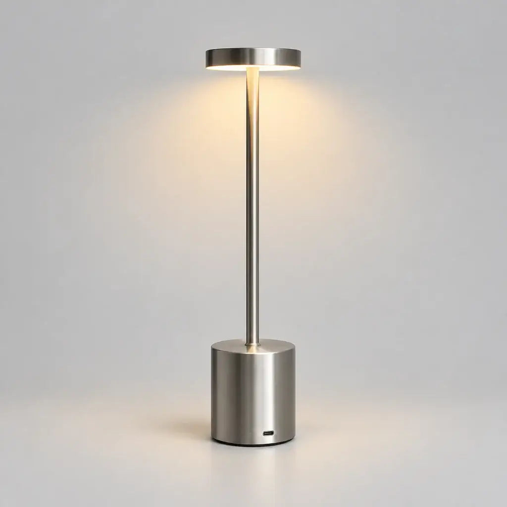 Hero - Modern Silver Cordless Table lamp, with light on, on grey background.