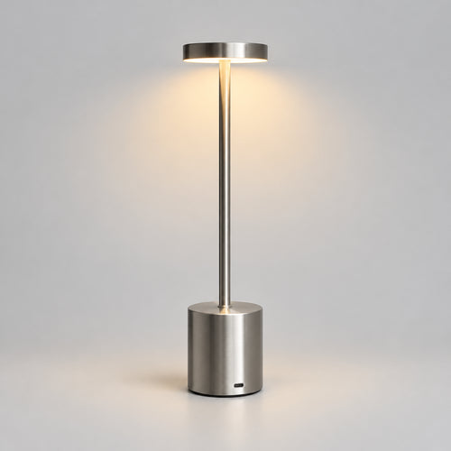 Hero - Modern Silver Cordless Table lamp, with light on, on grey background.