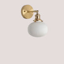 Timeless Elegance: Nordic White Porcelain Wall Lamp with gold mount and ribbed white shade.