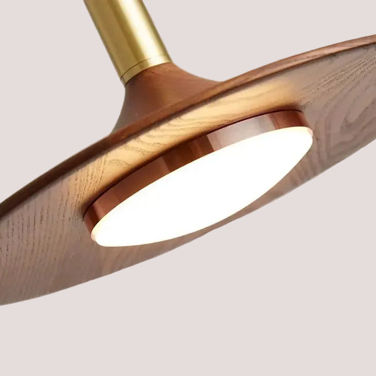 Close-up view of the Walnut Mid Century Modern Chandelier showcasing its unique design and warm lighting.