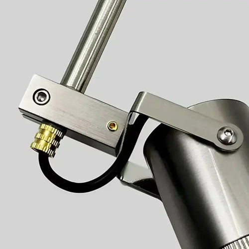 Close-up of a minimalist adjustable ceiling spotlight showcasing brushed steel finish and rotatable head feature.