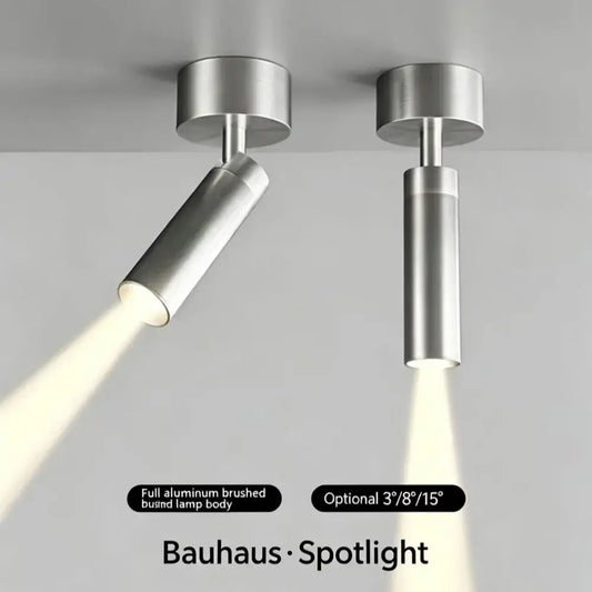 Minimalist LED spotlight in brushed aluminum design, illuminating a modern space.