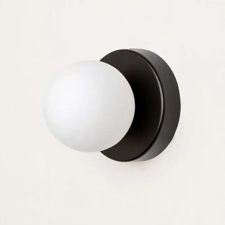 Colourful Macaron LED Wall Lamp 10/12cm mounted on wall with frosted glass bulb in black fixture.