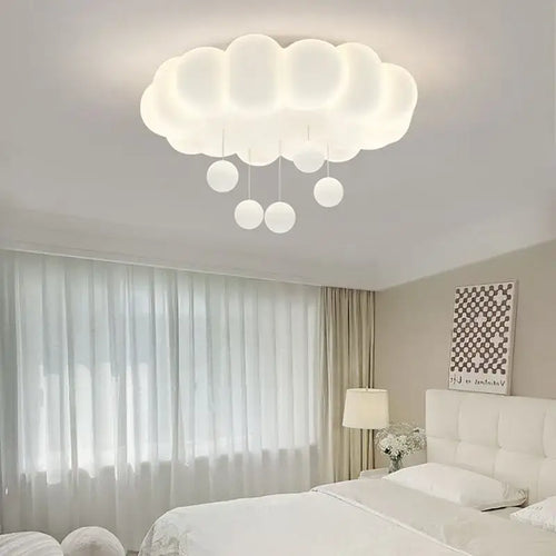 Modern white cloud-shaped LED ceiling light illuminating a stylish bedroom with soft, diffused glow.