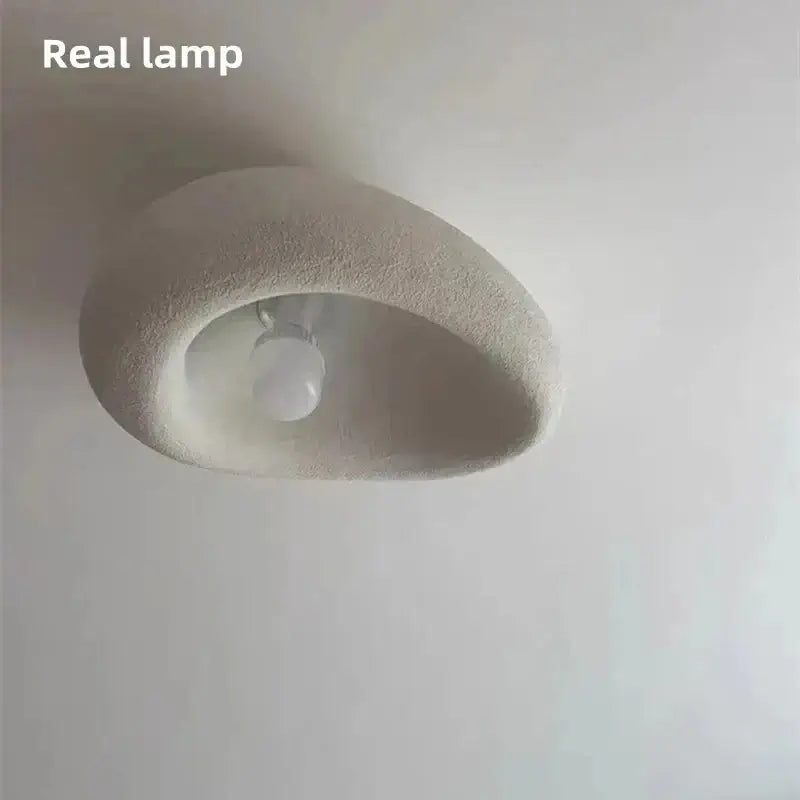 Organic stone ceiling light grey white with sculptural design and soft glow, enhancing contemporary interiors.