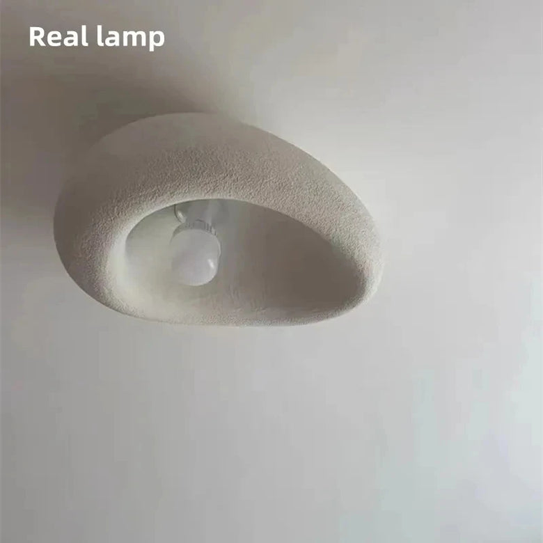 Organic stone ceiling light grey white with sculptural design and soft glow, enhancing contemporary interiors.