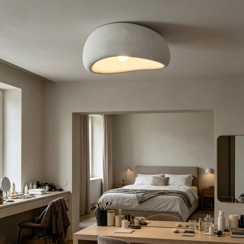 Organic stone ceiling light grey white illuminating a modern bedroom with soft, sculptural design.