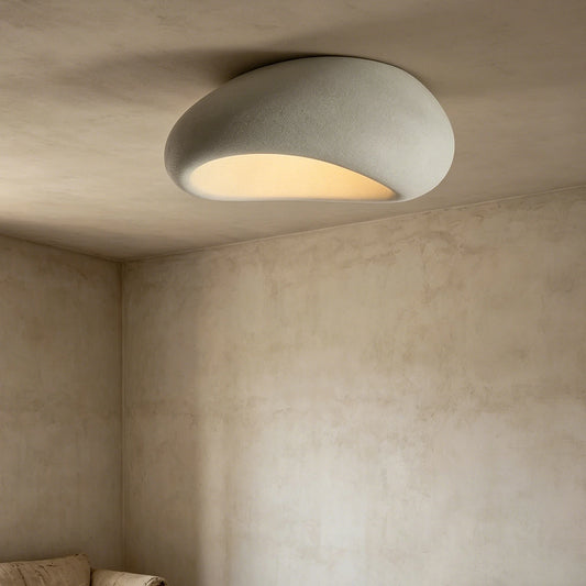 Organic stone ceiling light grey white illuminating a modern interior with a soft, sculptural design.