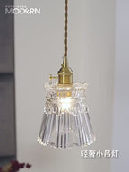 Elegant Glass Pendant Light with Brass Accents - Illuminate with Style hanging in a modern interior.