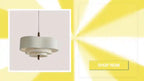 Elegant Linen Fabric Chandelier hanging light fixture against a yellow burst background.